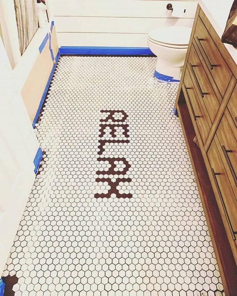 Bathroom with relax word forming on the tile floor