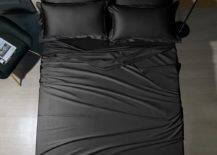 Bed with black sheets and pillows