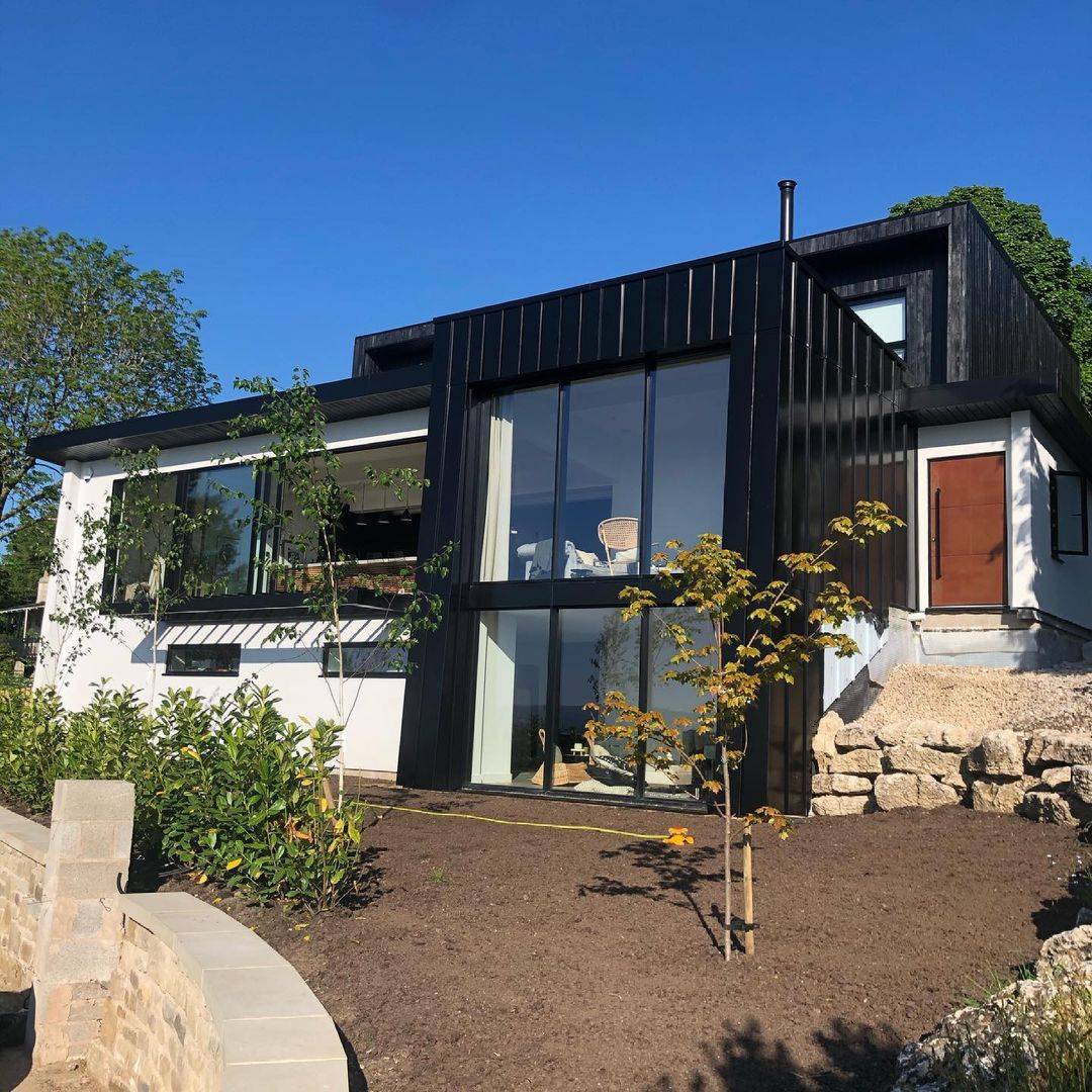 Black and white box house with glass panels