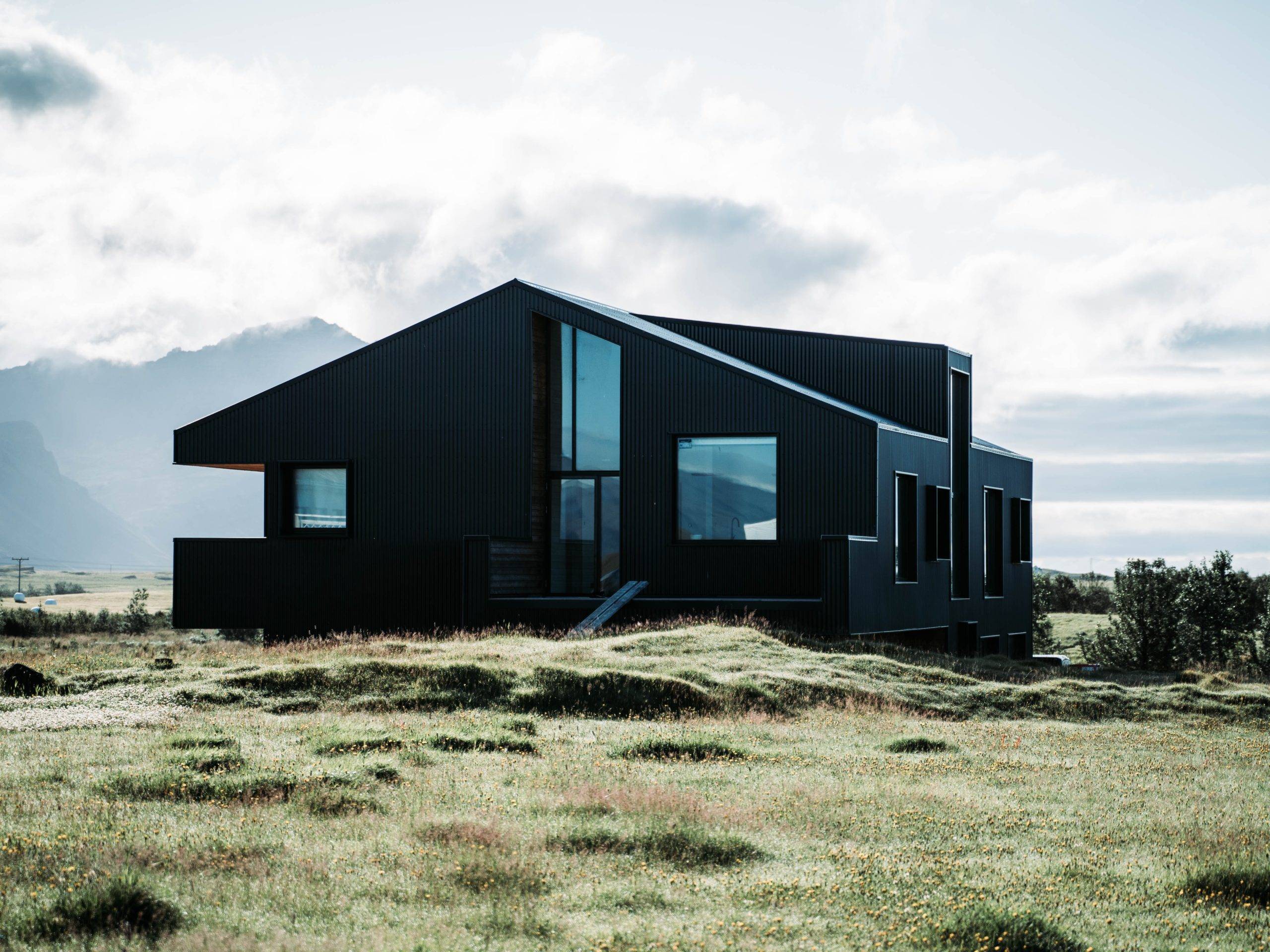 Black house in the middle of bare land