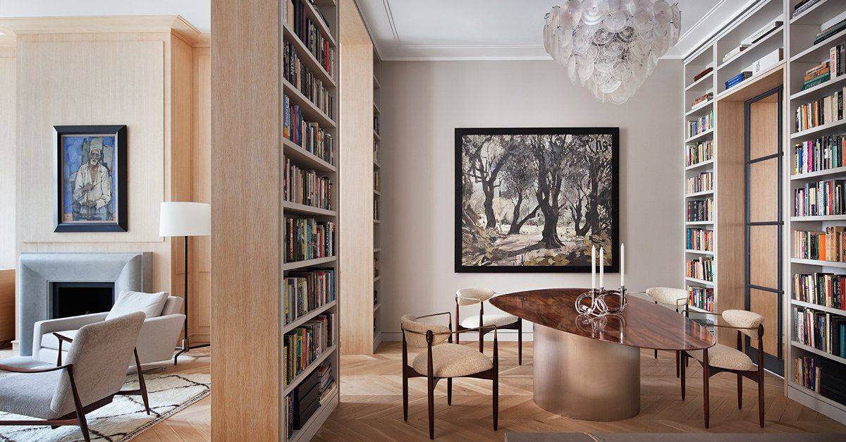 Bookshelves from floor to ceiling surround this contemporary dining area while also creating doorways