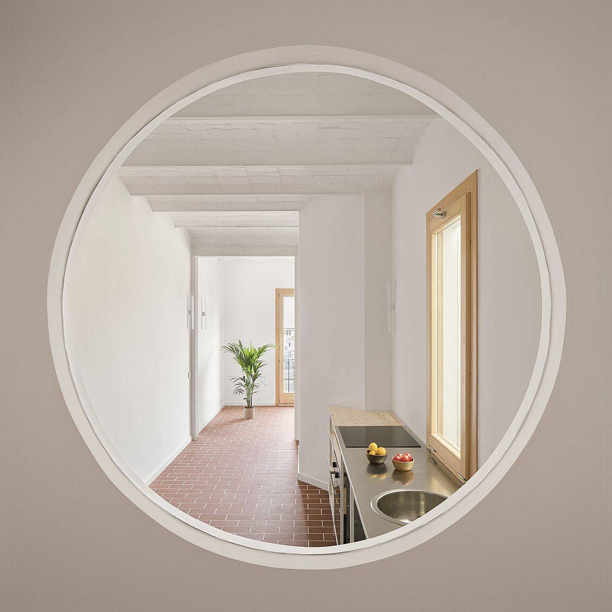 Circular-window-connects-the-kitchn-and-the-living-area-with-the-dining-space-or-secondary-room-42282