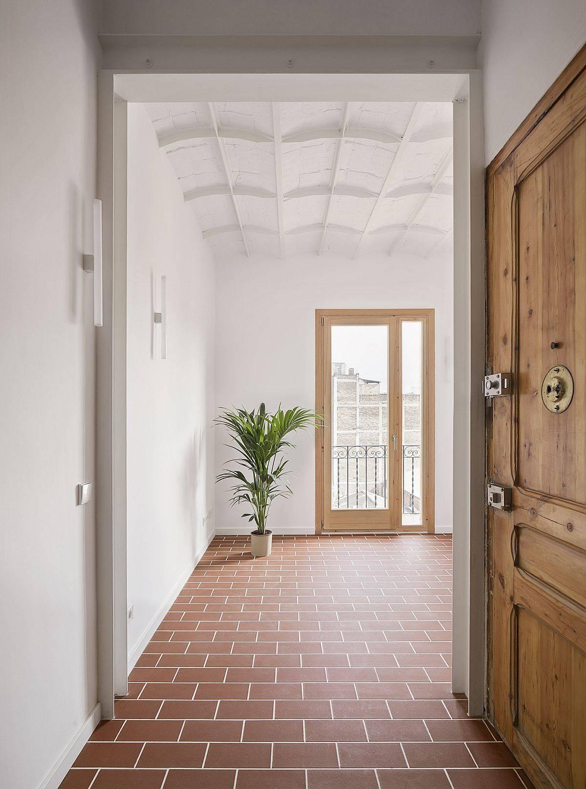 Classic ceilings and Terracotta tiles bring textural and old world charm into this small Barcelona home