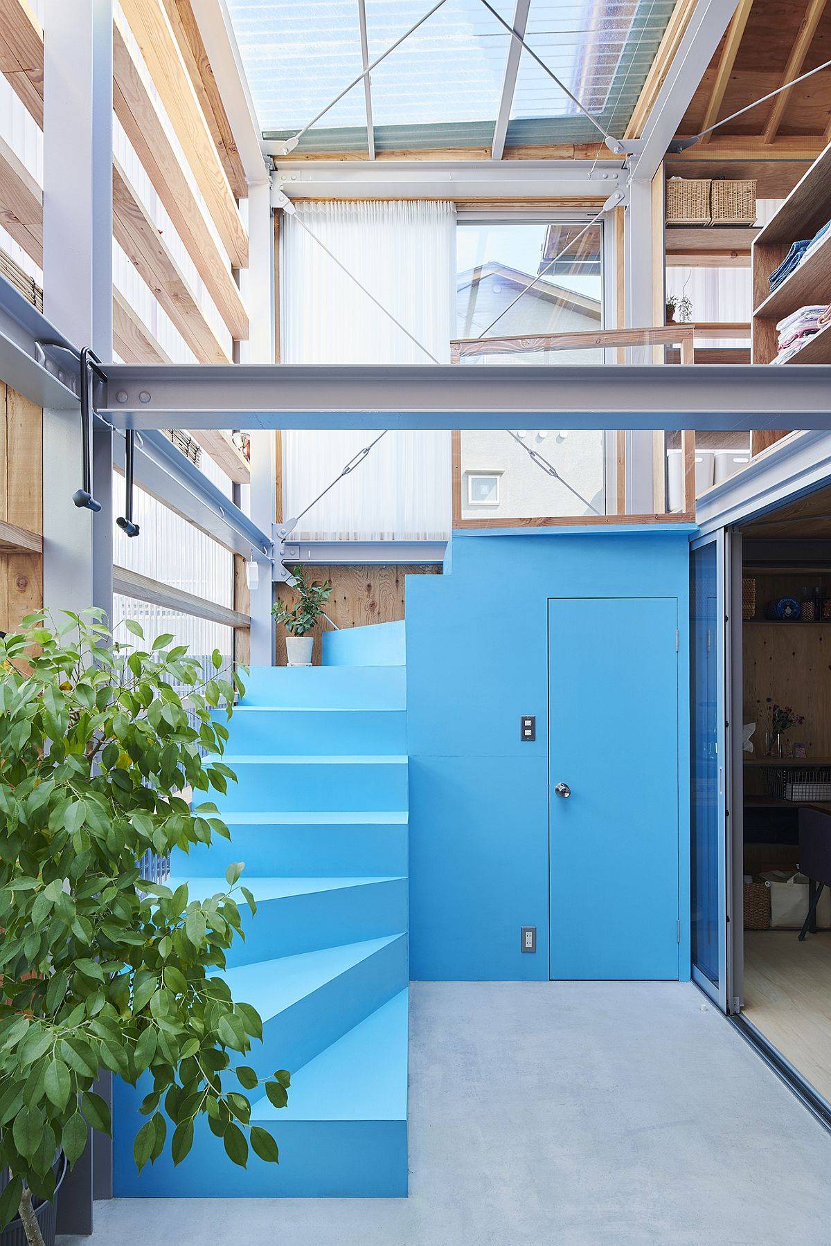 Custom blue staircase and room leading to the upper level of the house