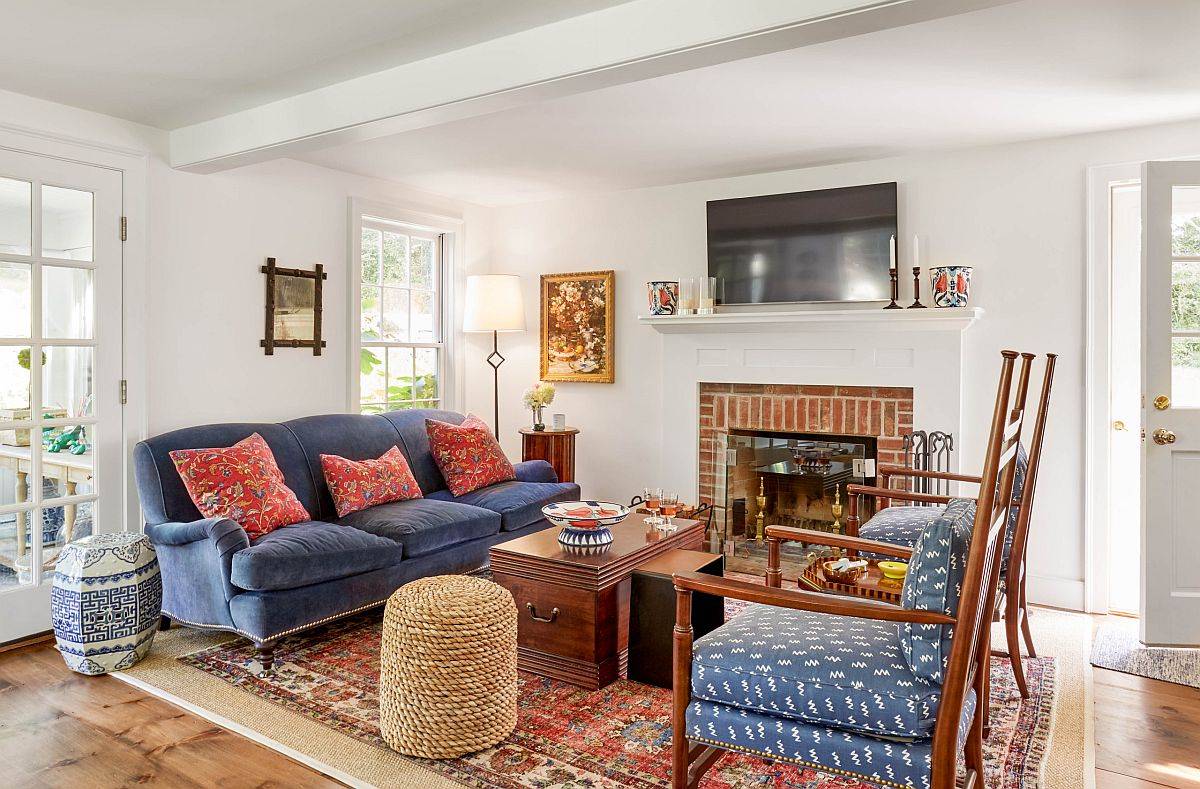 Decor, fireplace and brilliant colorful couches ramp up style in this modern farmhouse family room