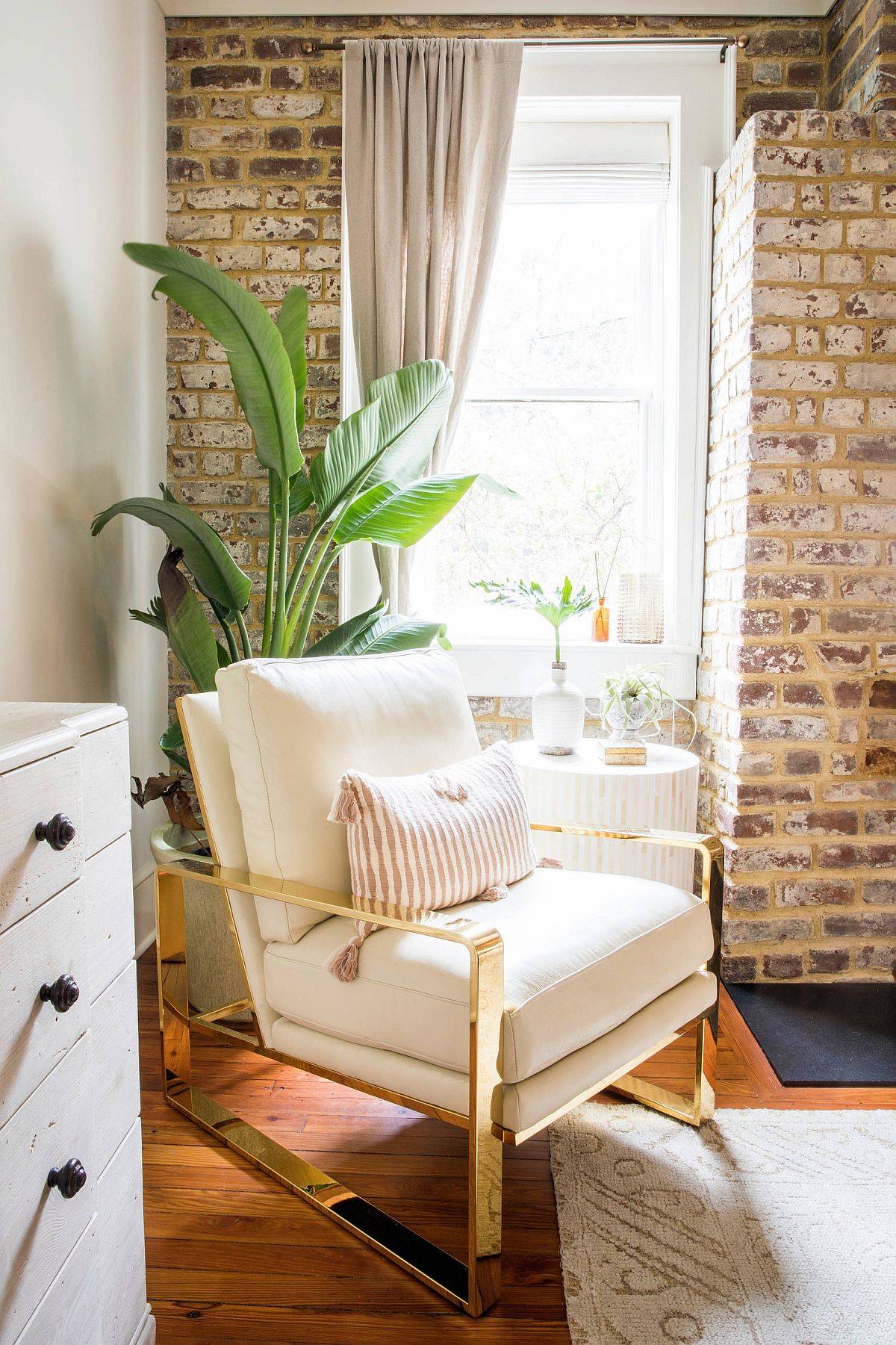 Decorating the corner of the modern industrial bedroom with a comfy chair and an indoor plant