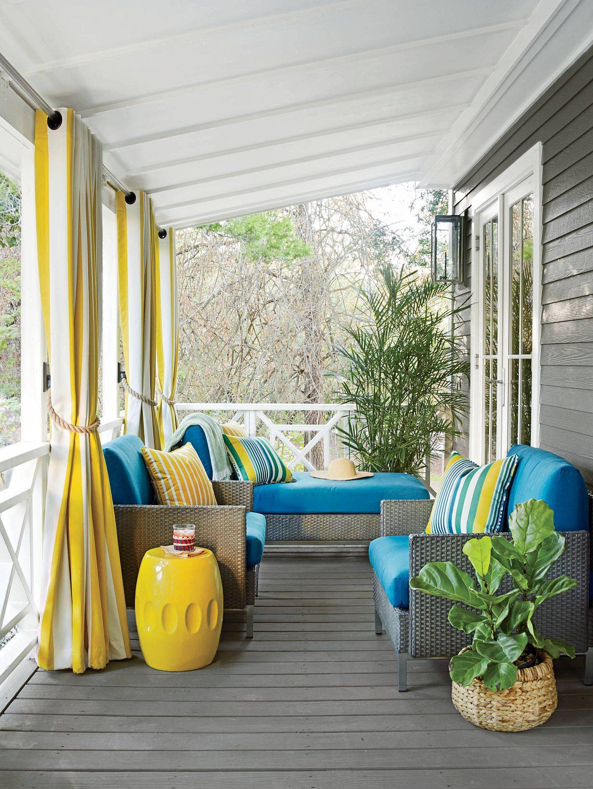 Delightful use of blue and yellow for the small beach style porch in gray