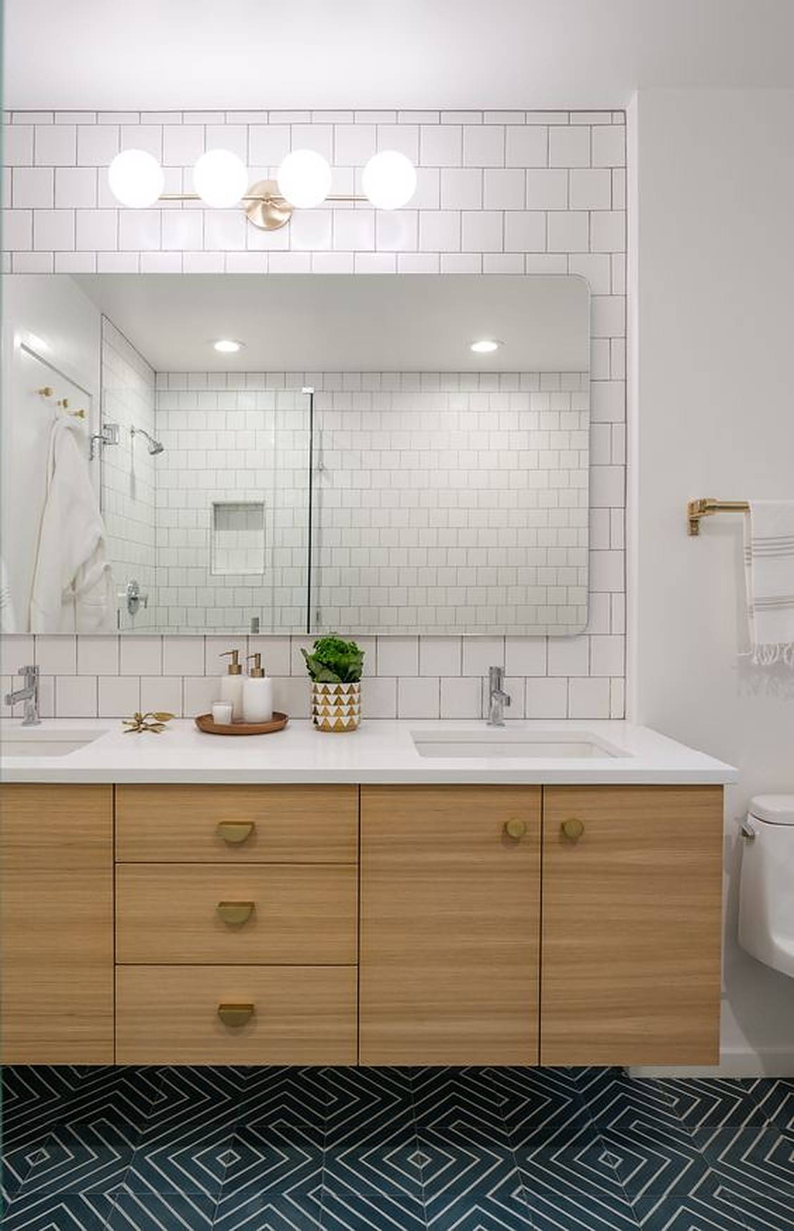 Double bathroom sink with green plant