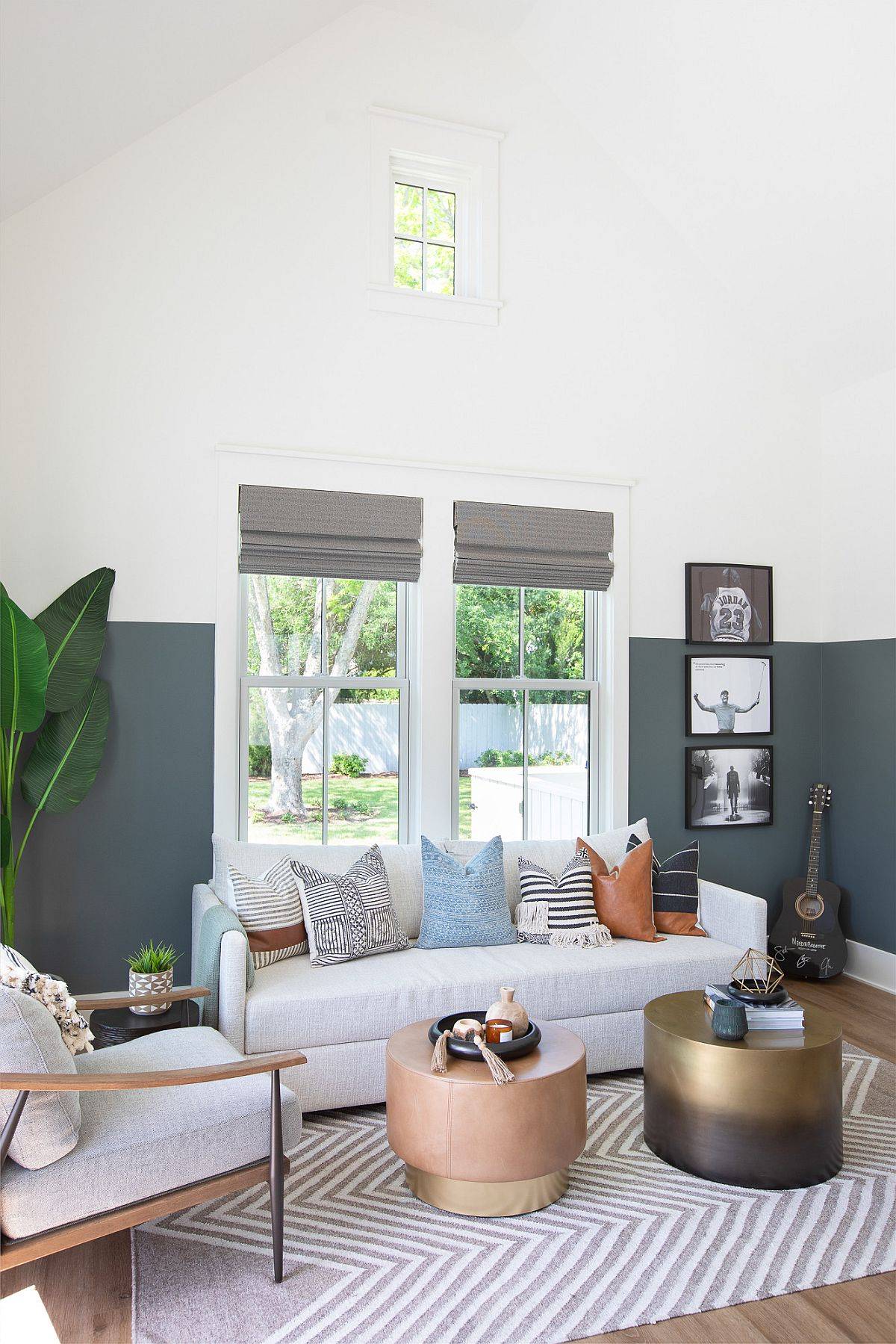 Double-height family room in gray and white with slanted ceiling and color scheme in gray and white