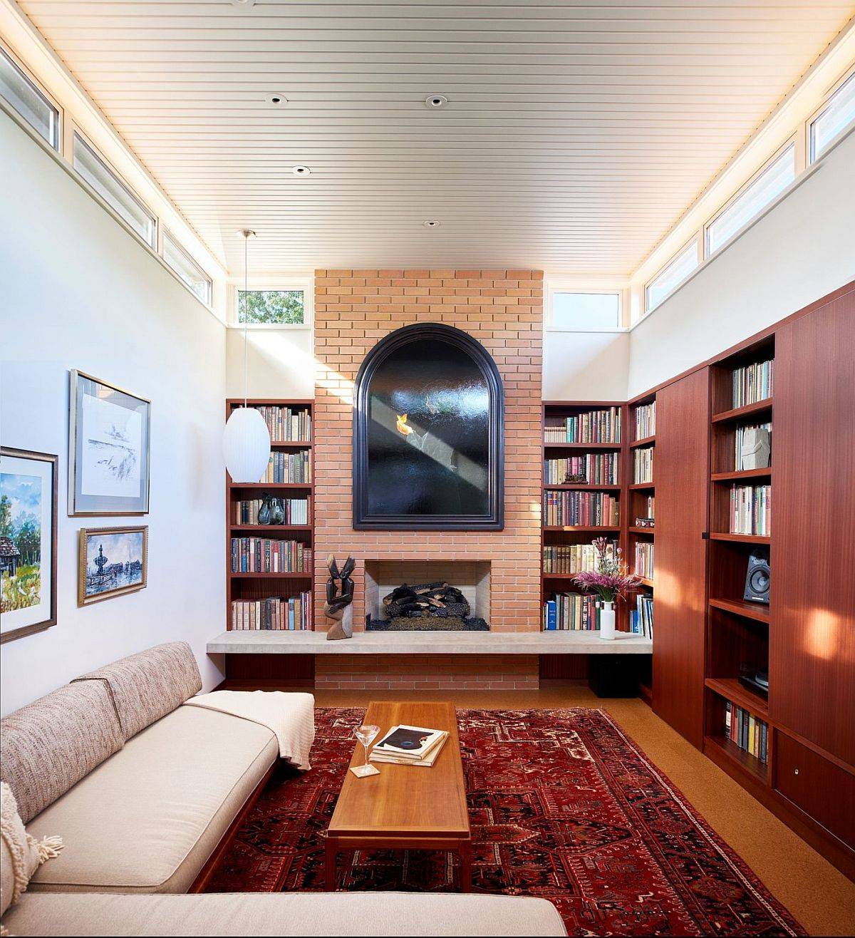 Family-room-with-brick-walls-large-bookshelves-and-clerestory-windows-that-usher-in-natural-light-19344