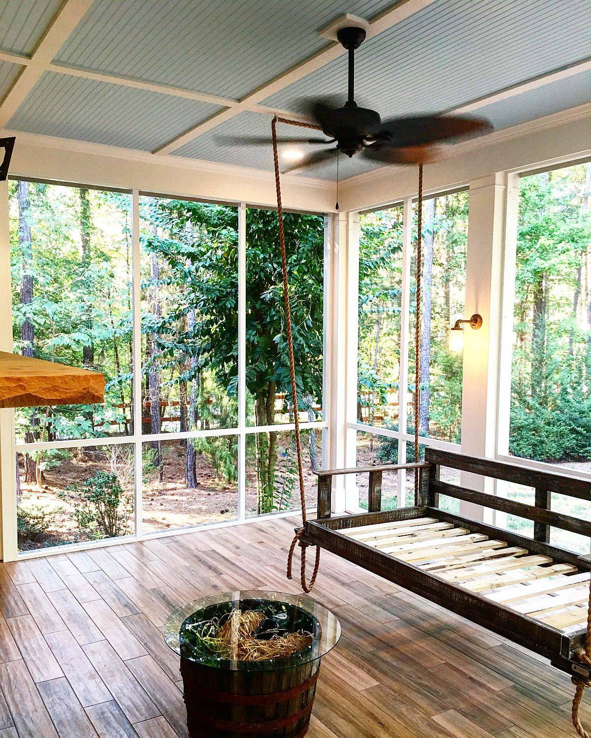 Gray ceiling and a tropical fan give thi shabby-chic porch a unique identity