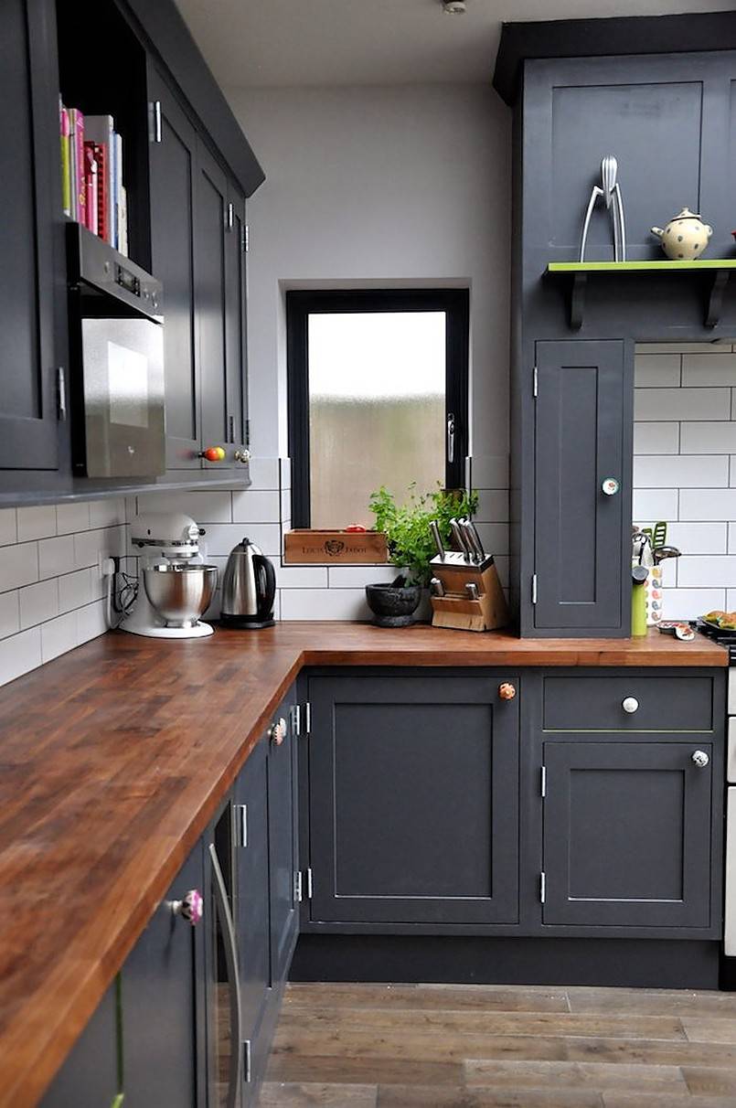 Gray kitchen cabinets and butcher block countertop