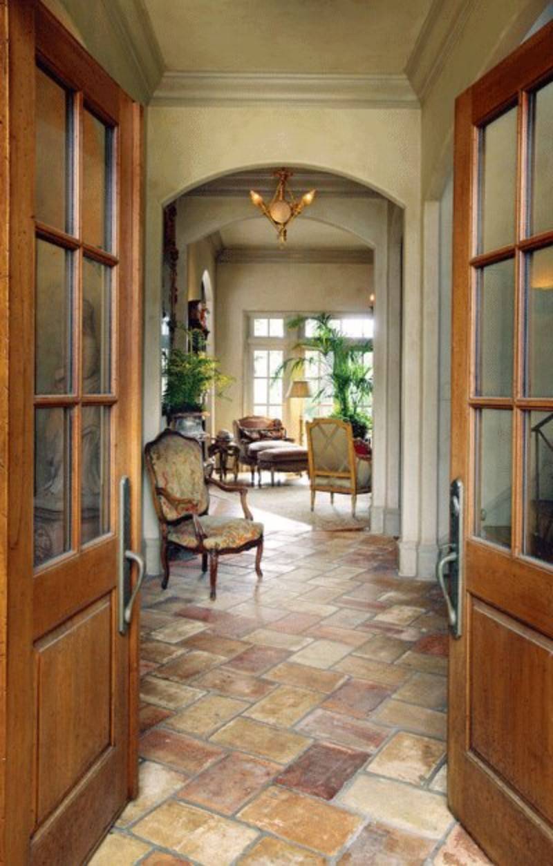 Hallway with a chair and stone flooring