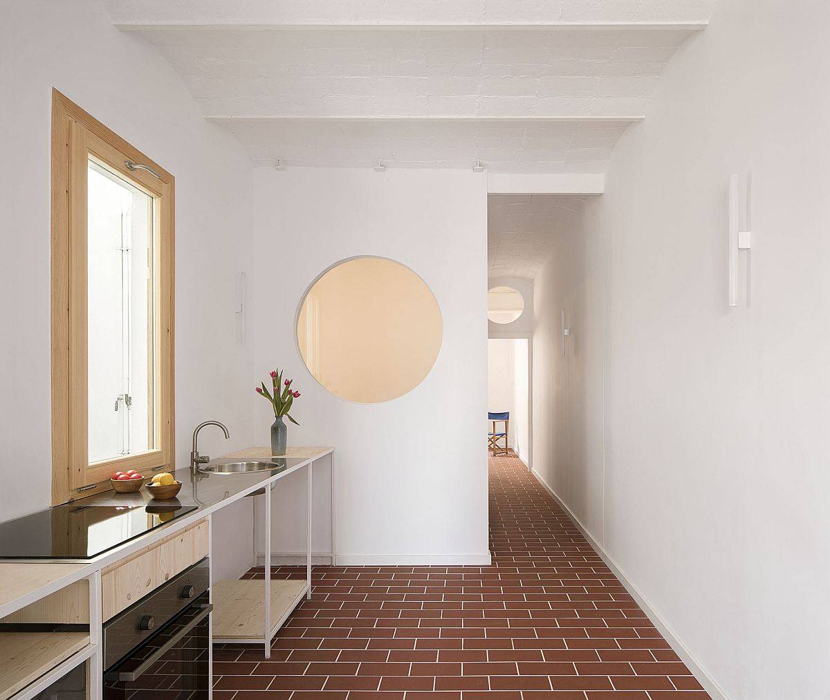 Dark Apartment in Barcelona Finds New Life with Open Rooms and Round Windows