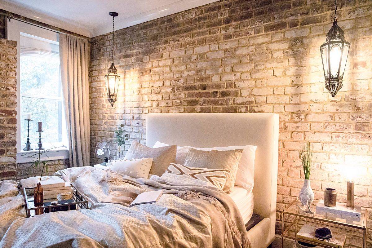 Large tufted headboard in the bedroom brings comfort and contrast to the rugged backdrop