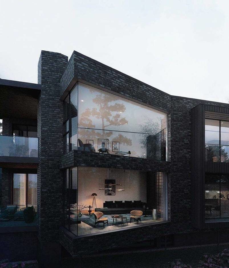 Living room visible through glass wall of a black house