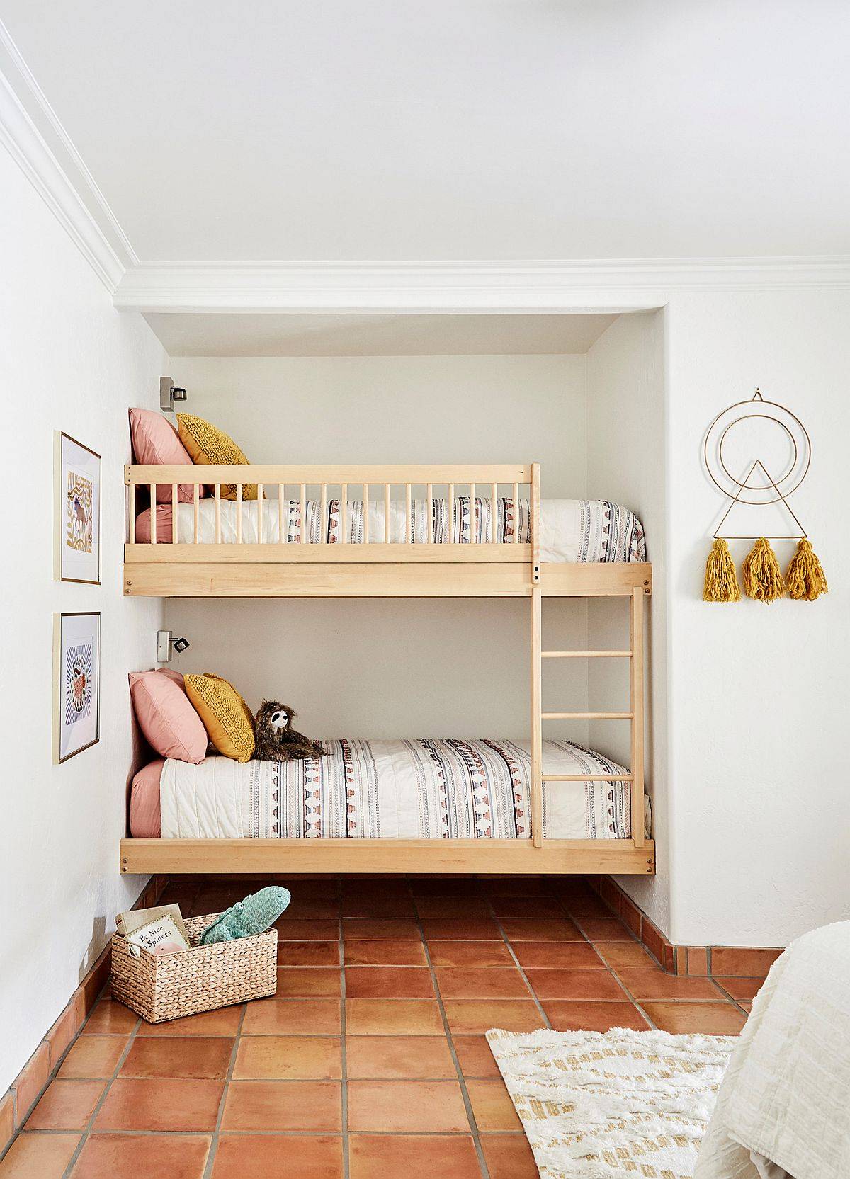 Lovely kids' bedroom with bunk beds in the corner and terracotta floor tiles