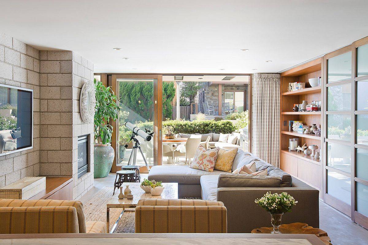 Modern beach style family room with woodsy elements thrown into the mix