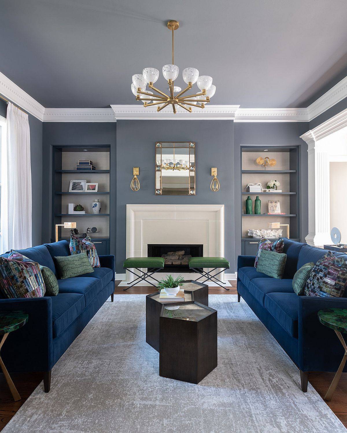 Modern living room in gray with bright blue sofas and space-savvy design