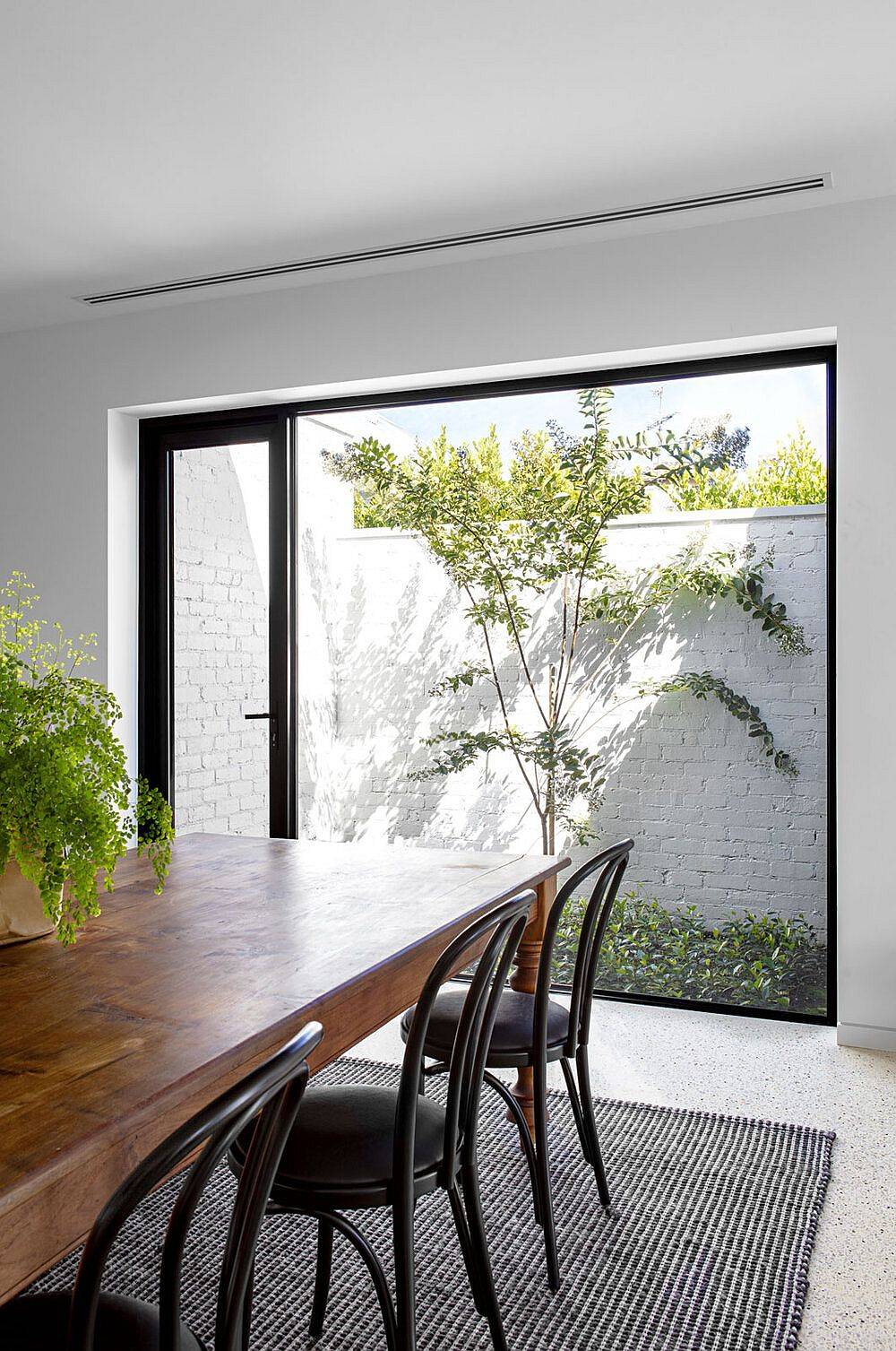 Picture window adds greenery and light to the dining area along with the kitchen