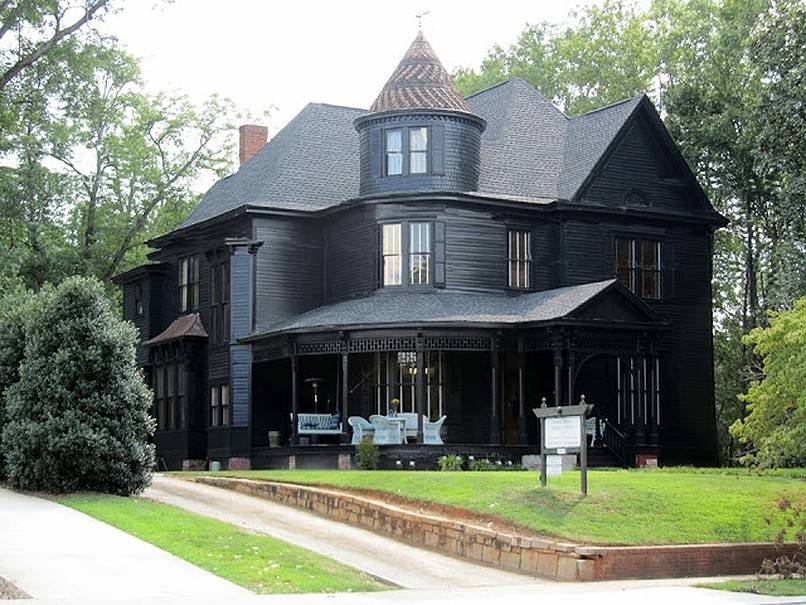 Rustic black house with a tower