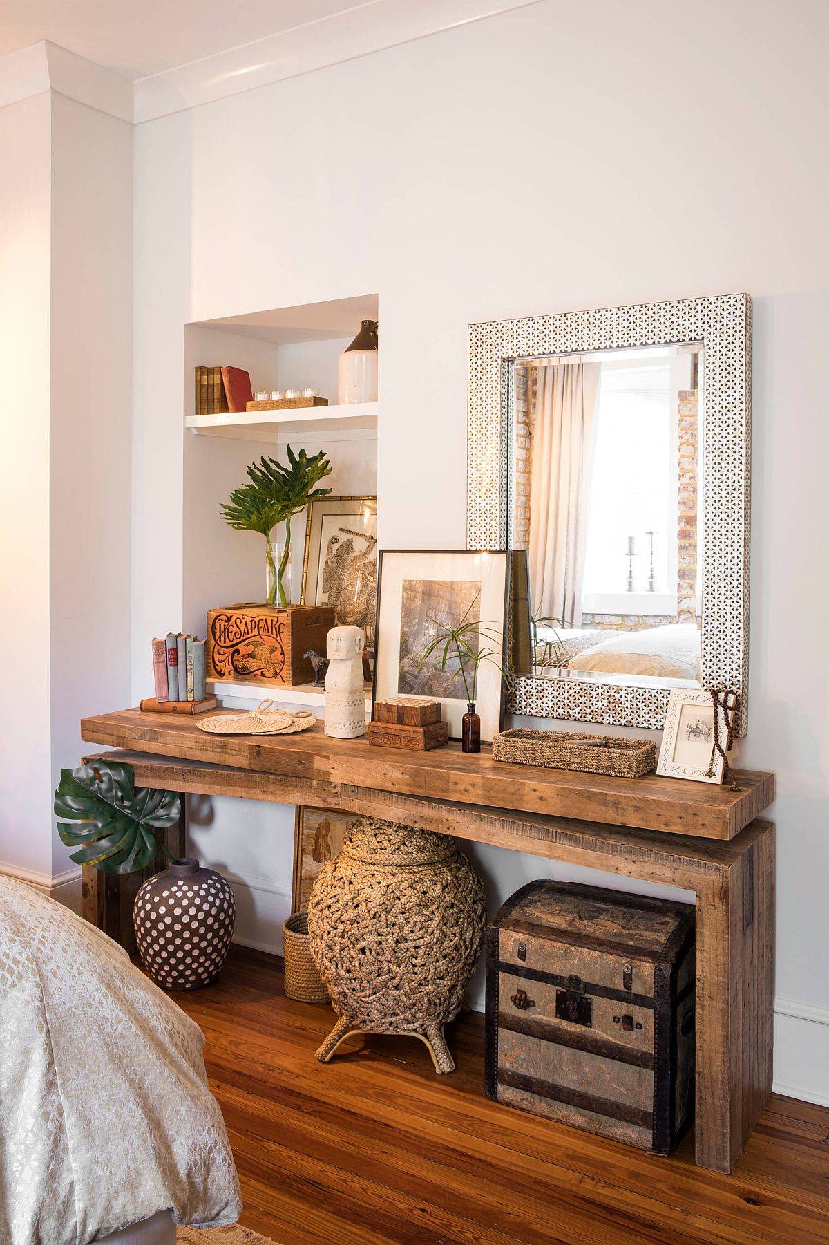 Slim natural wood table in the bedroom with smart decorative pieces