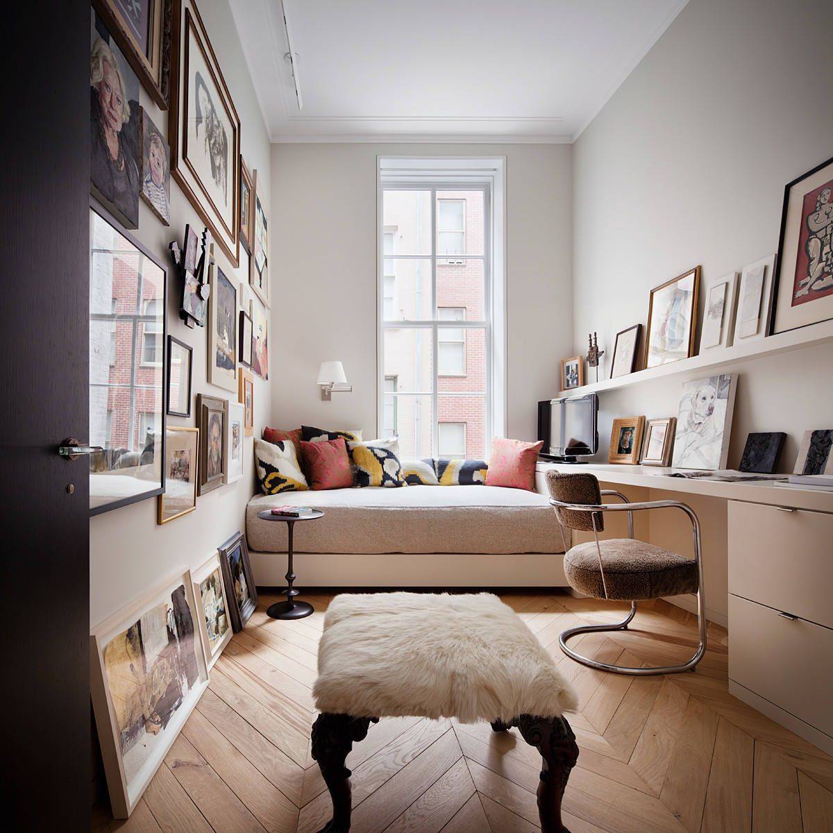 Small home office with platform bed and beautiful framed photographs and art pieces all around!