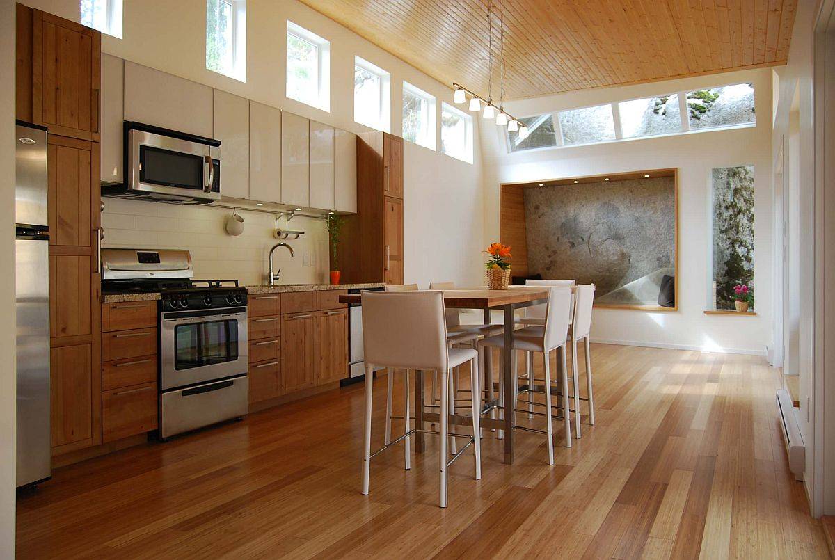 Spacious modern kitchen and dining area of Vancouver home is bathed in ample natural light