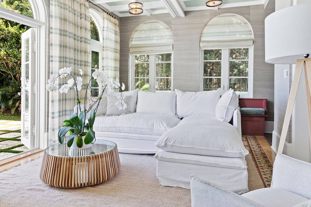 Textured gray walls along with white sofa and plaid curtains in the cheerful family room