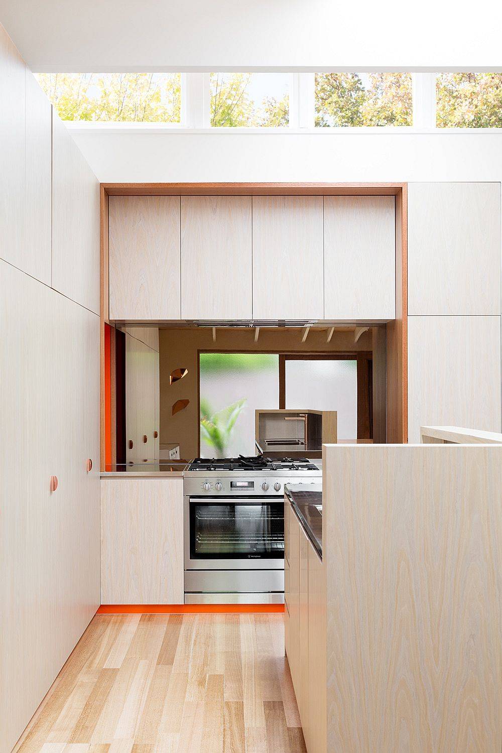 Tiny kitchen in wooden and white with creative use of clerestory windows