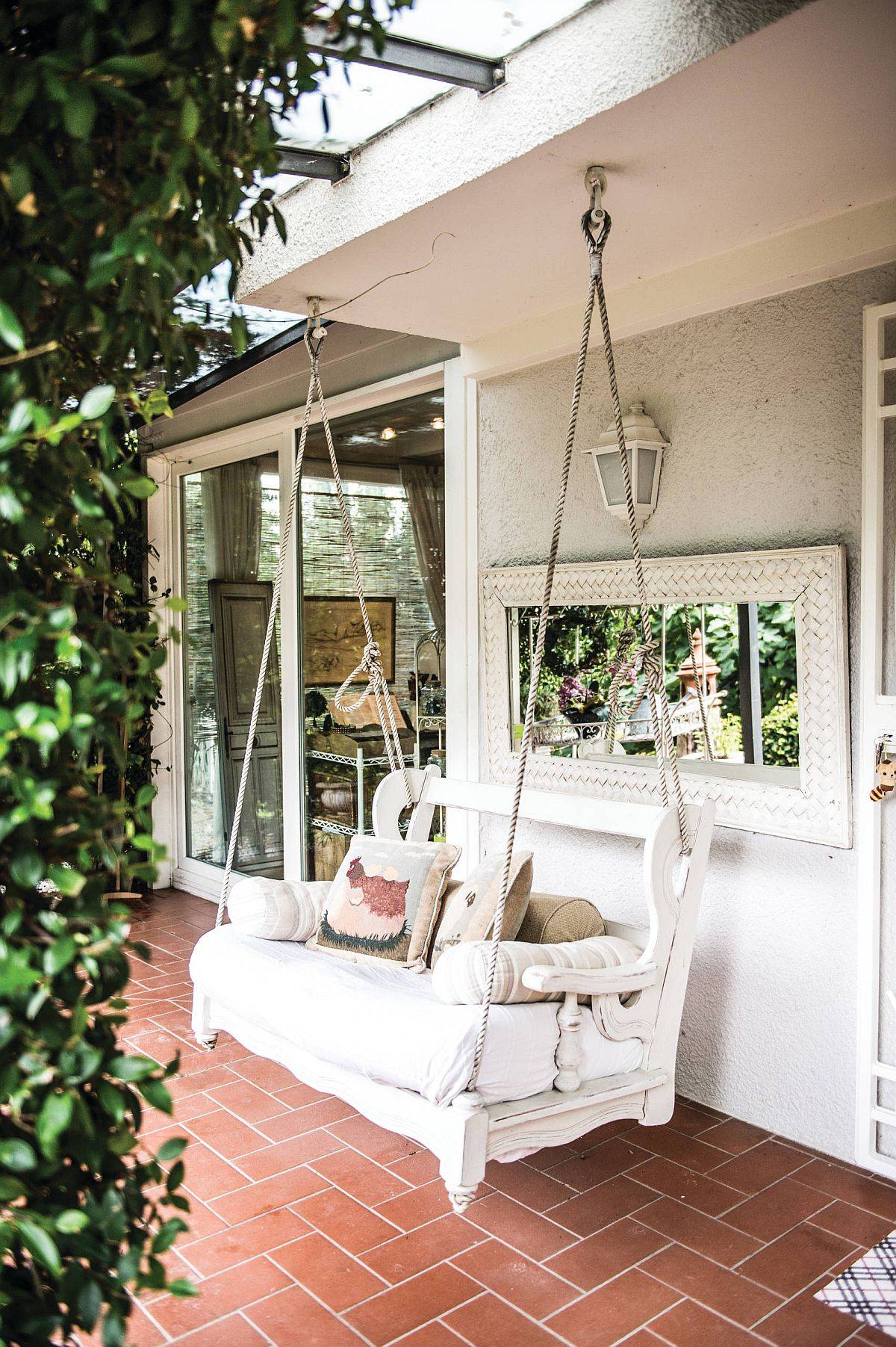 Tiny porch with swing seat and terracotta tiles