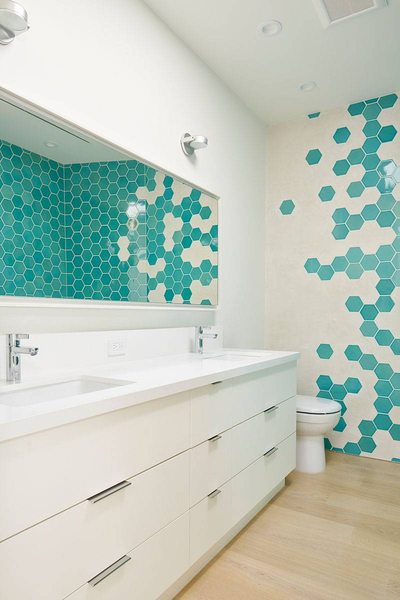 Turquoise and white hex tiles on bathroom wall