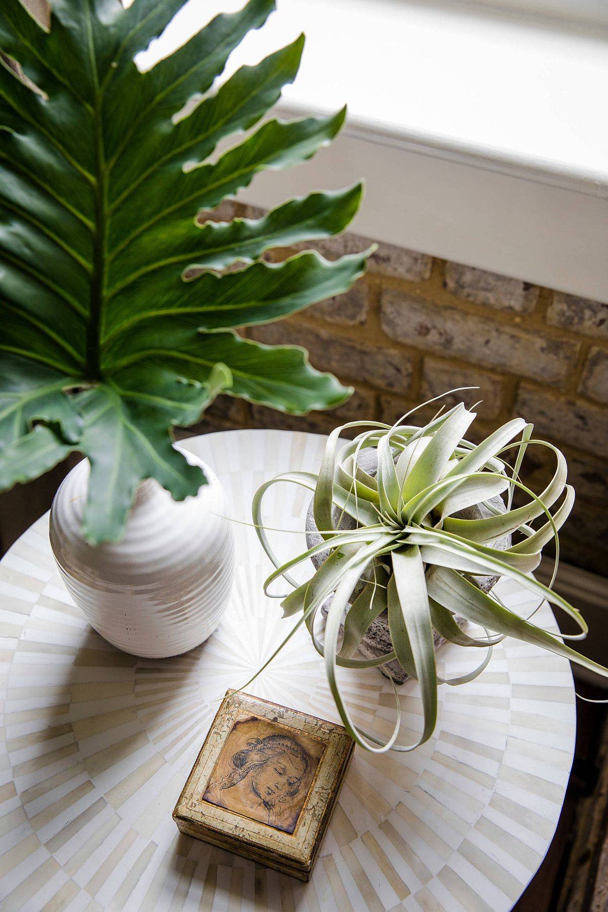 Using indoor plants to decorate the small side table in the industrial bedroom