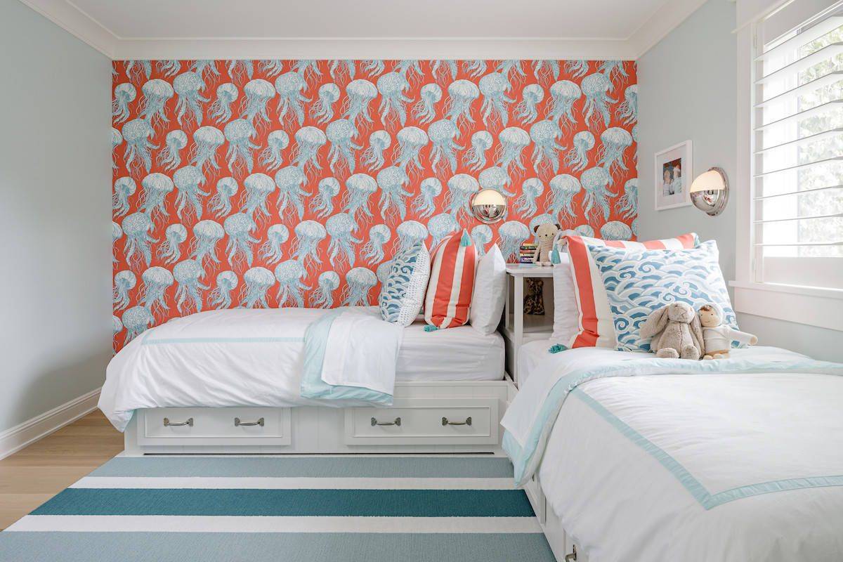 Wallpaper and accent pillows bring color into this kids' room