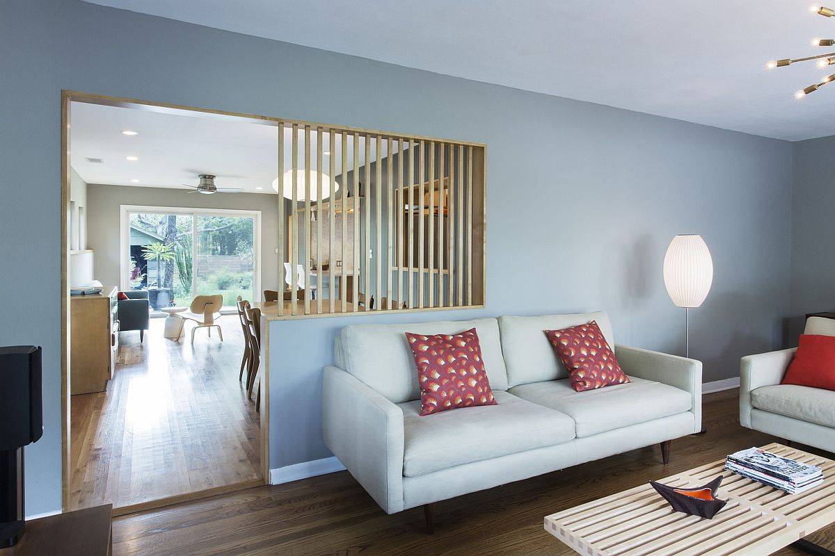 Wooden slats create a partition between the living area and the dining room