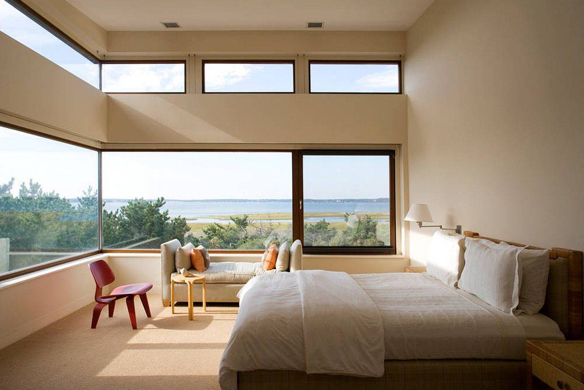 Wrap-around windows along with clerestory windows bring stunning scenery into this bedroom