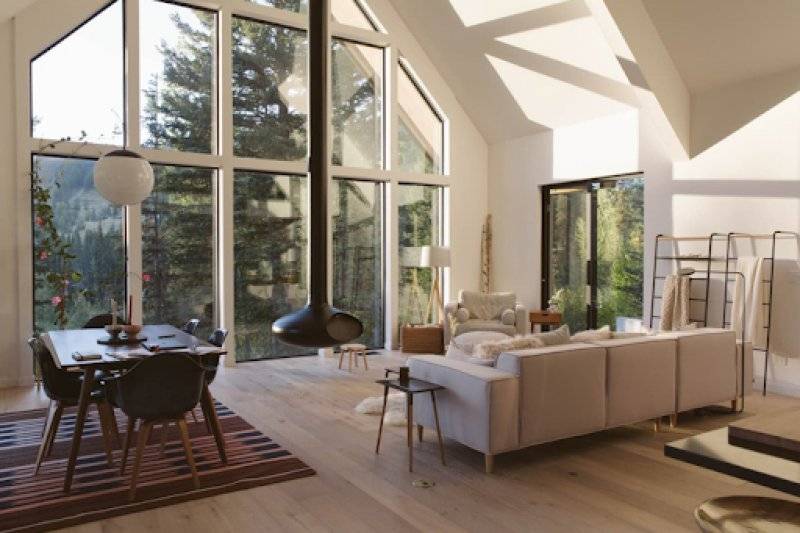 Cozy Cabin Living Area with Fireplace and Floor to Ceiling Windows