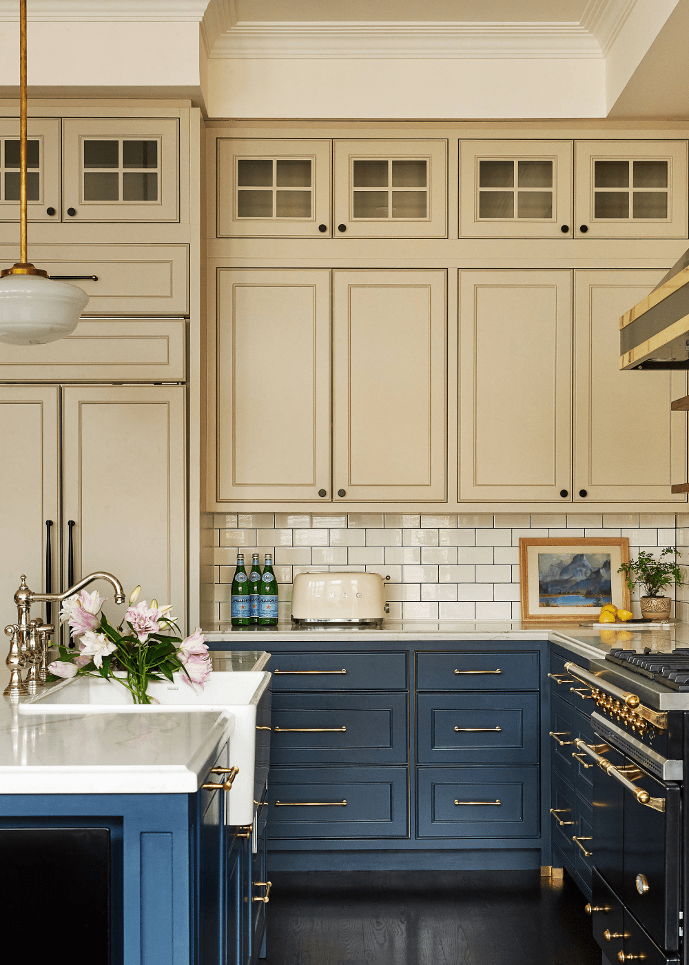 warm beige upper kitchen cabinets with dark blue lower cabinets