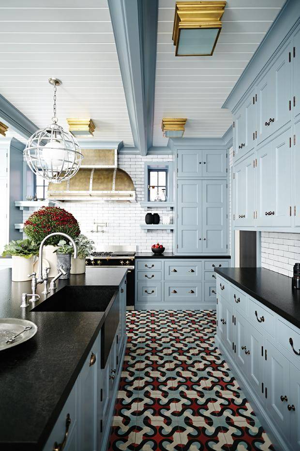 dark granite kitchen countertops with blue cabinets and patterned tile floor
