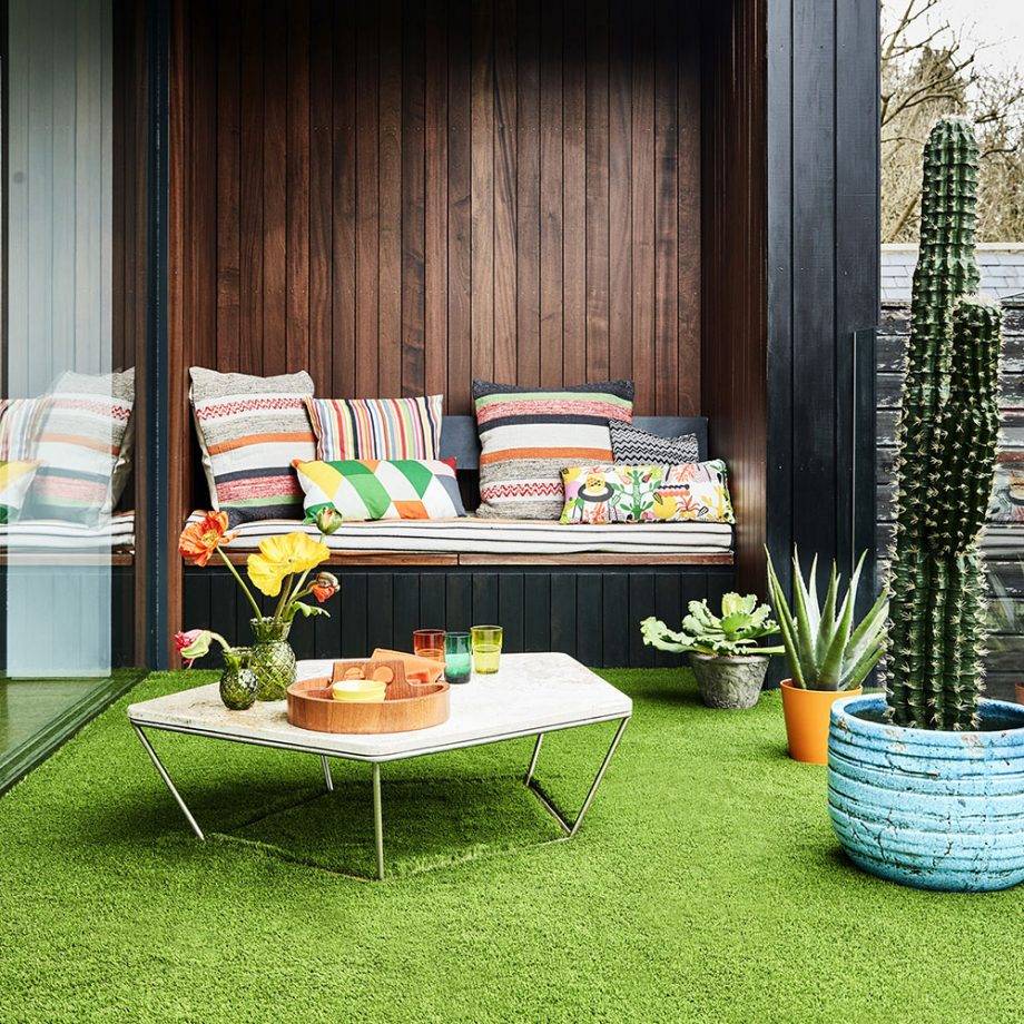 faux grass on balcony with colorful furniture