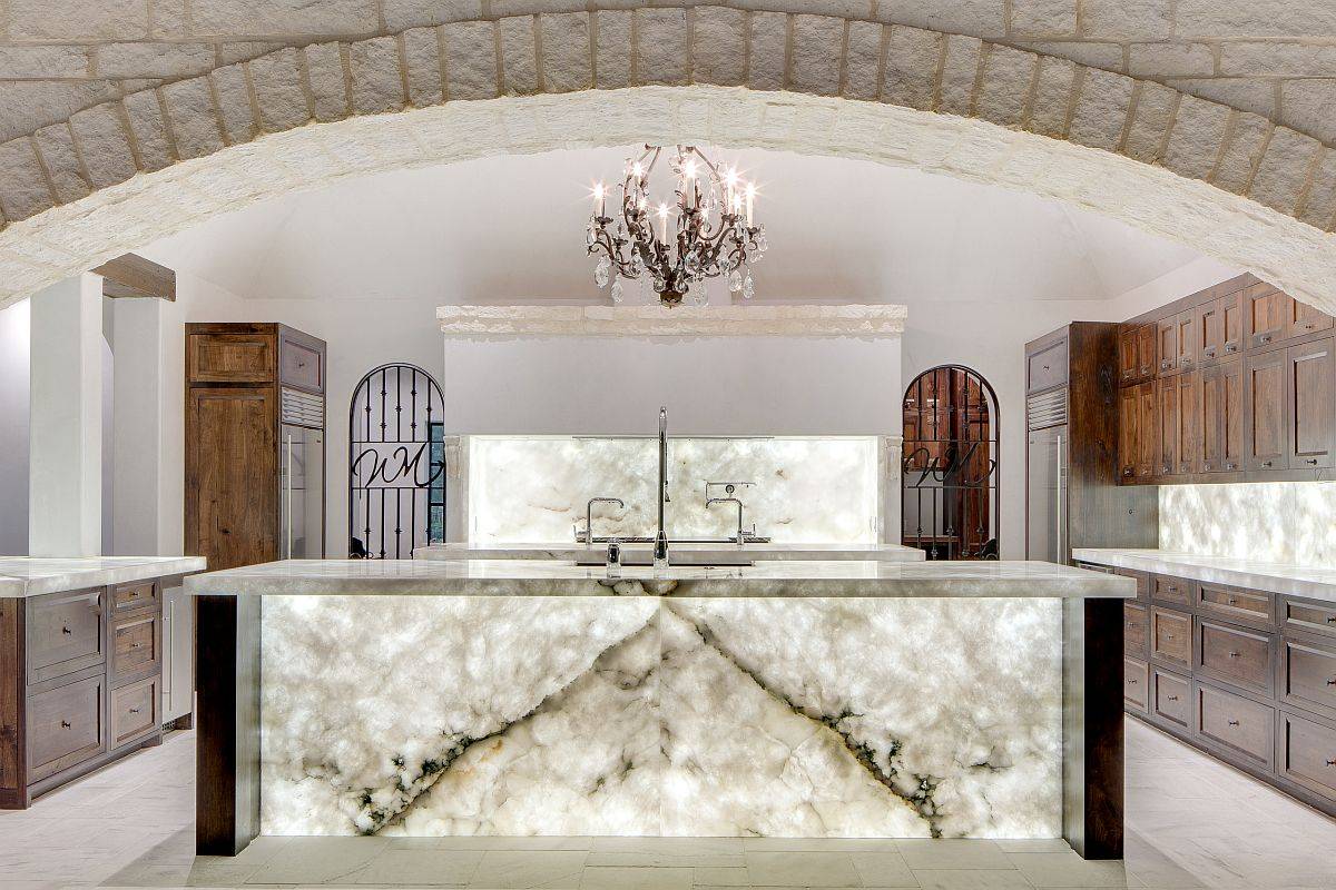 Awesome stone kitchen with Cristallo Quartzite kitchen island and backsplash that is illuminated by backlit LED panels