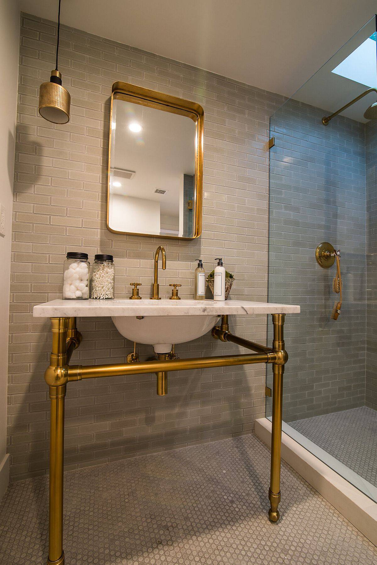 Bathroom with Spanish tile and sink that fetaures a gold base