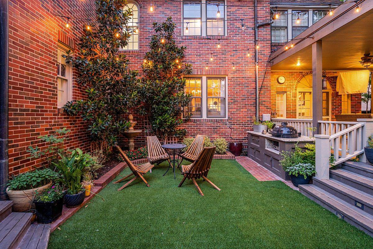 Beautiful green courtyard with brick walls in the backdrop and sparkling lighting looks just picture perfect