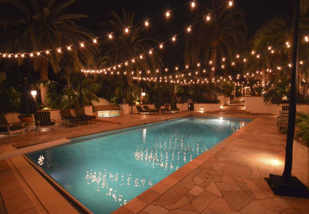 pool at night with string lights