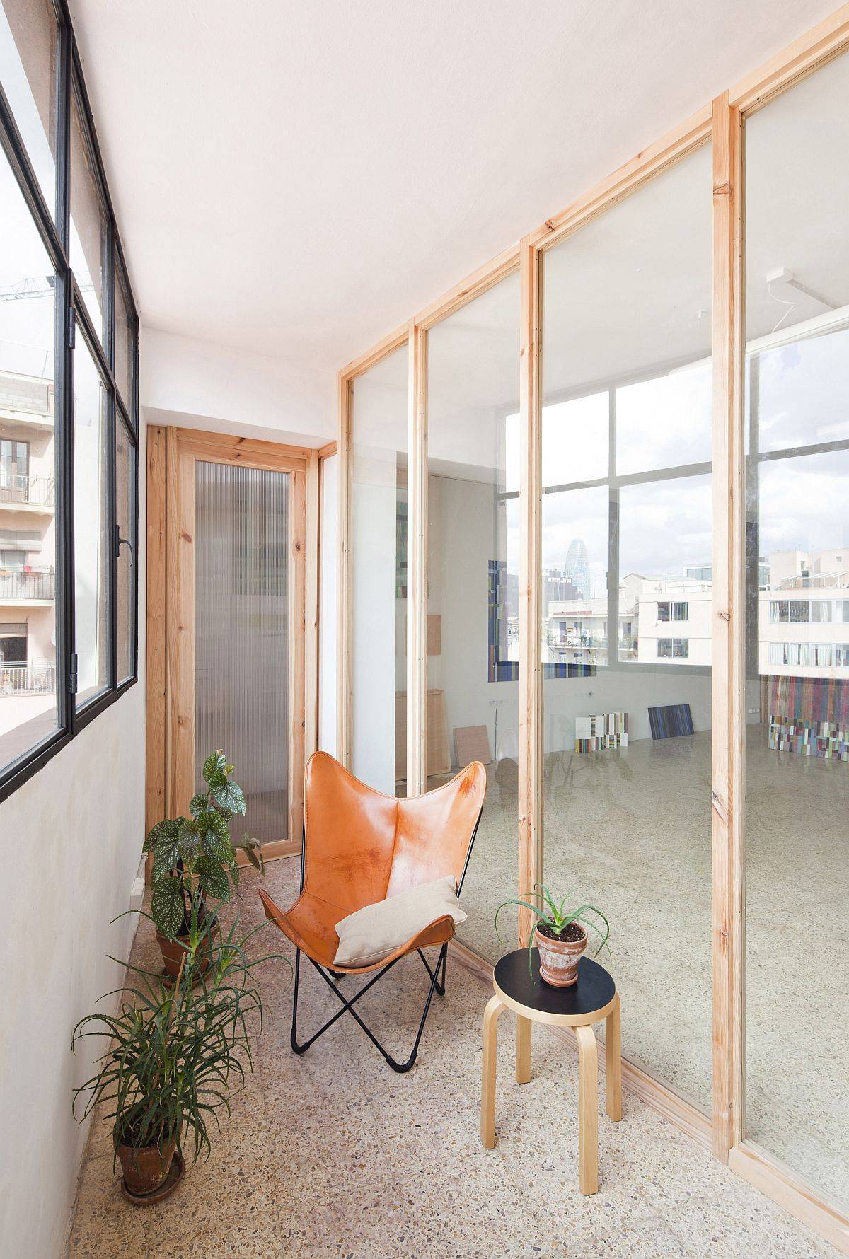 Creative use of wooden frames and glass walls brings new spatial configuration to this Barcelona home