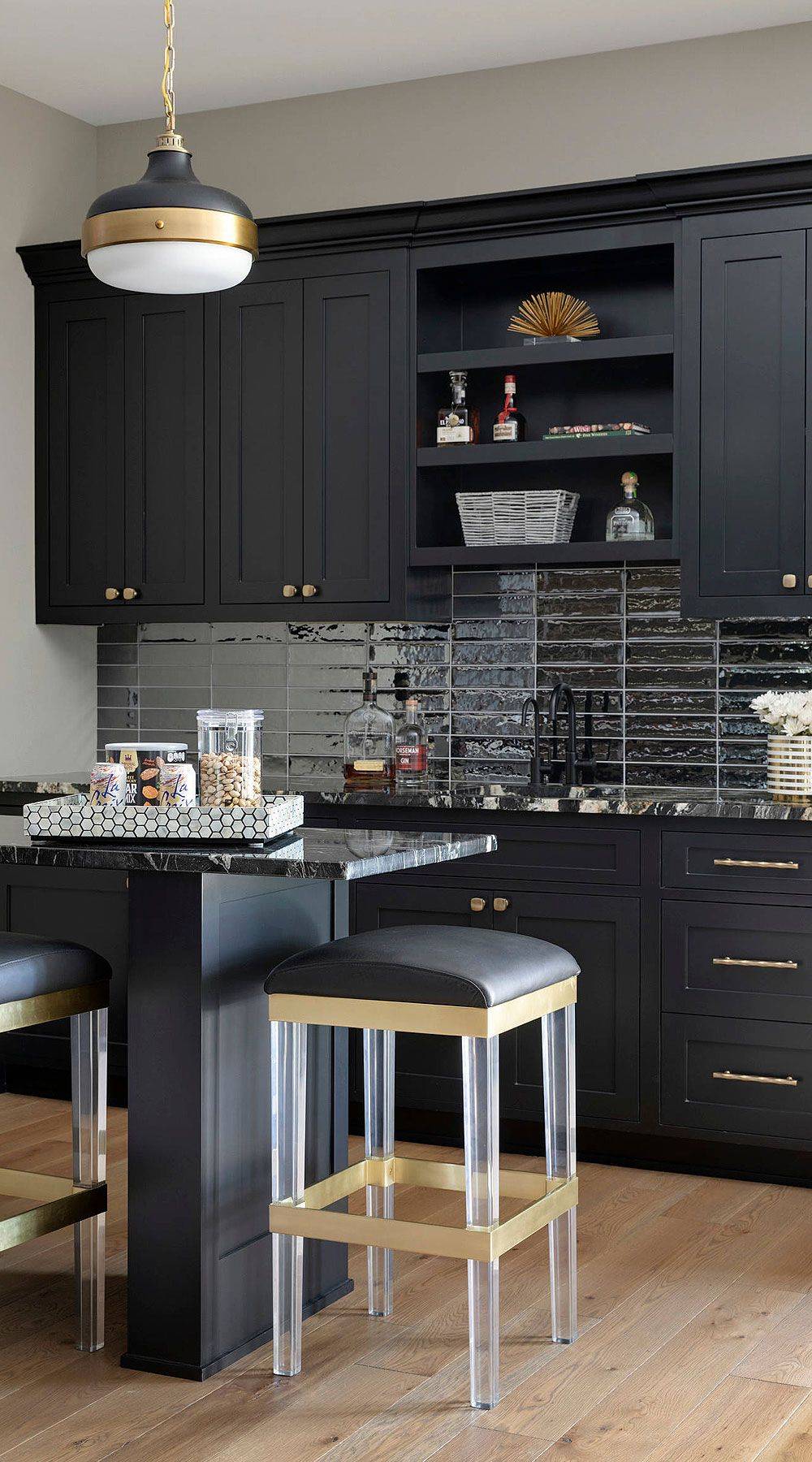 Dark and Gold Themed Kitchen with Dark Backsplash.