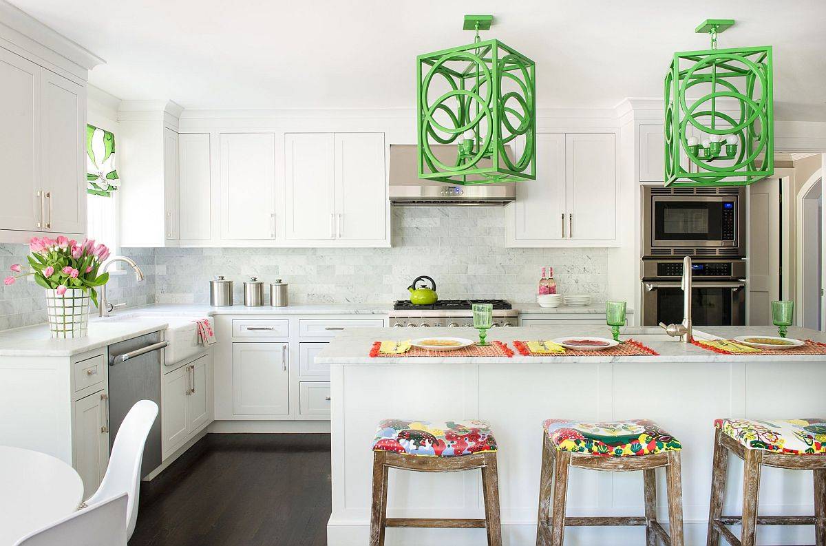 Eye-catching over-sized pendant lights bring both color and pattern to this white New York kitchen