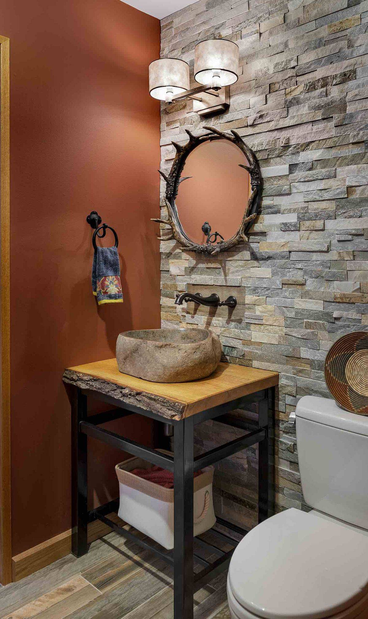 Frame around the mirror ends up being the biggest showstopper in this small rustic powder room!