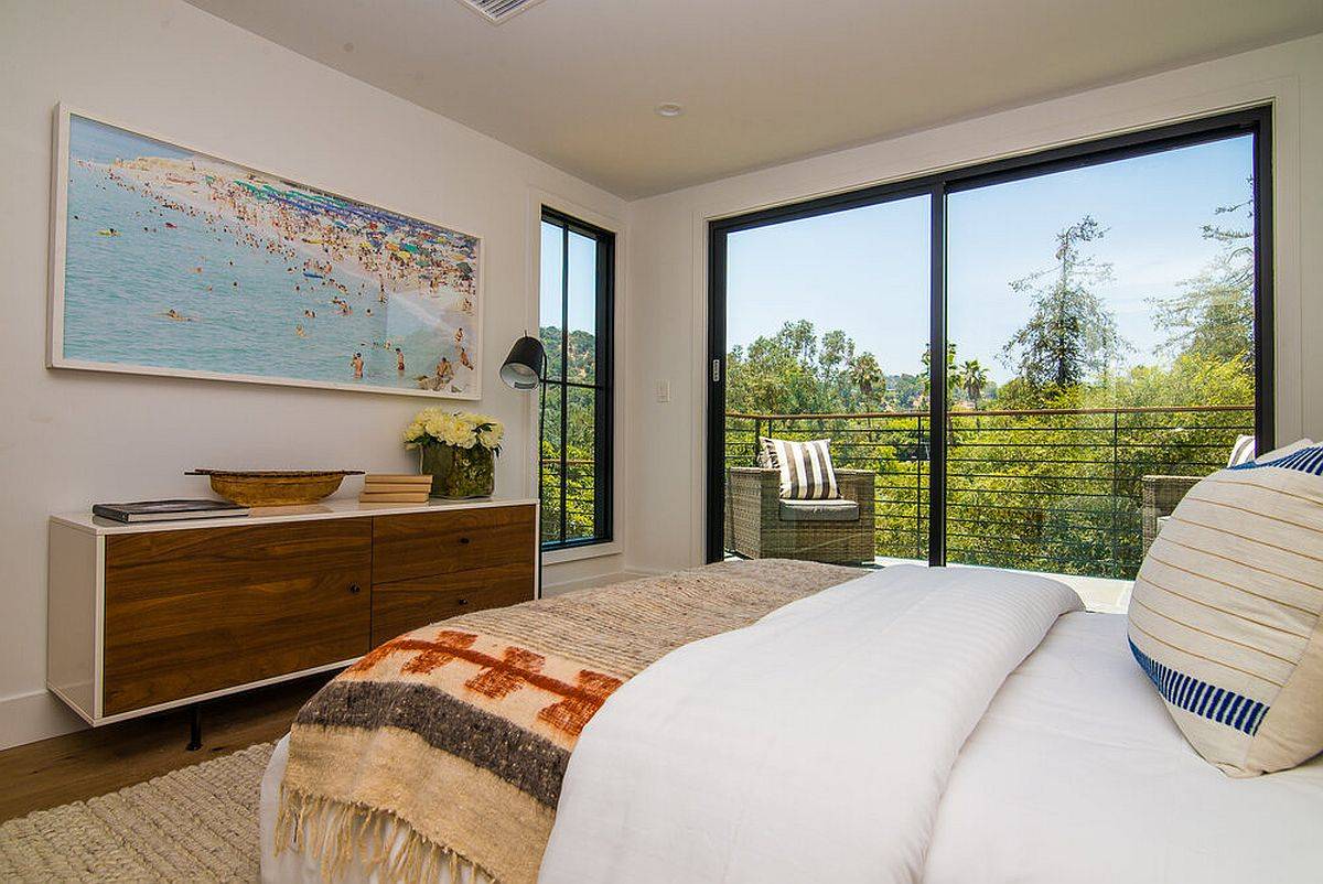 Gorgeous master bedroom with a view of Hollywood Hills in the distance and greenery all around