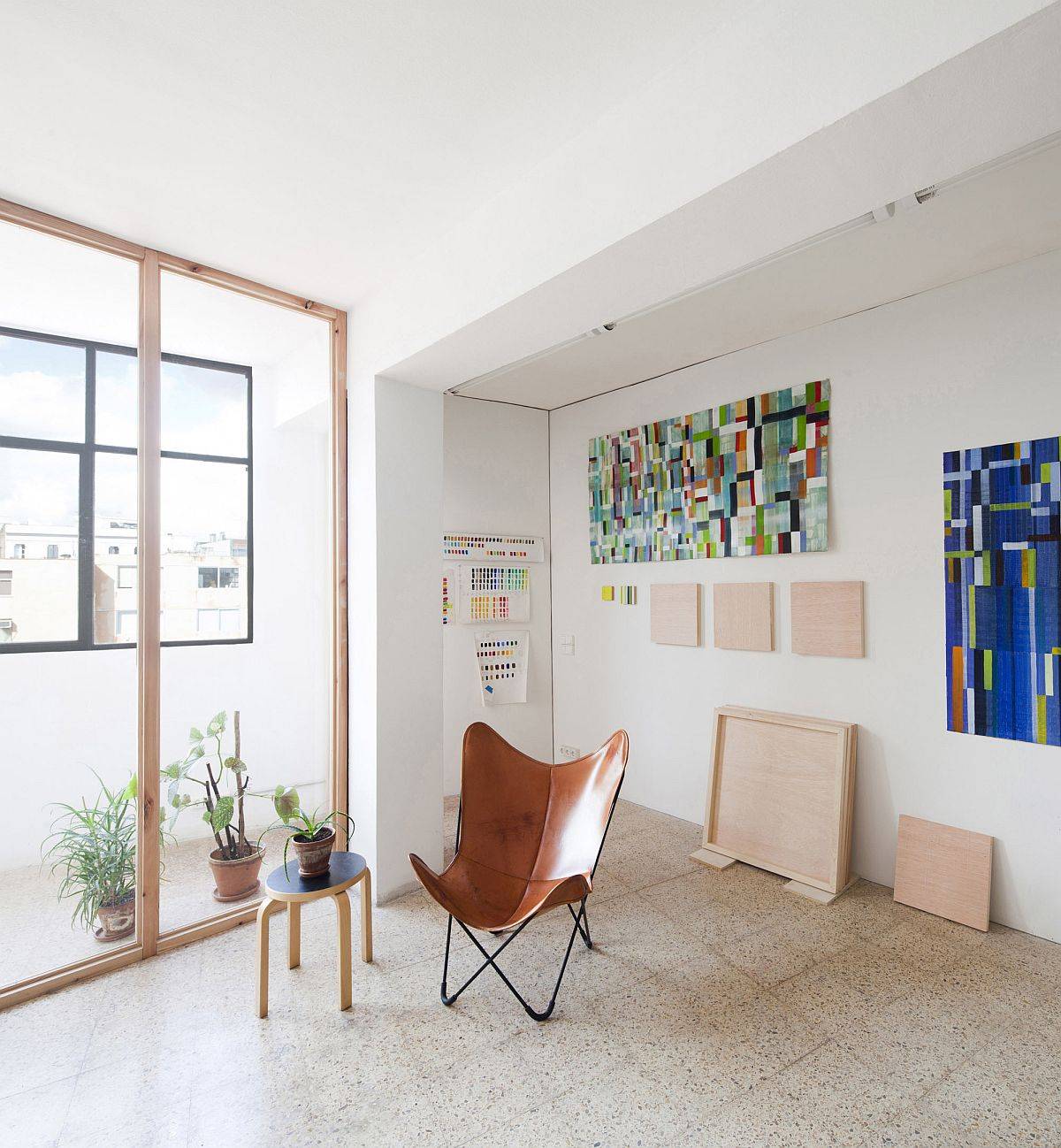 Improved office interior with fabulous wall art pieces and the iconic Butterfly chair in leather